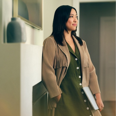Woman standing in office waiting for a meeting room.