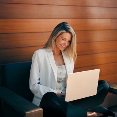Employee asking Workday's conversational AI a pay question on a laptop.