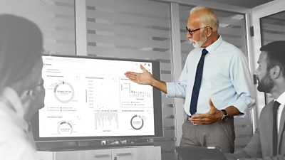 Man with tie looking at charts.