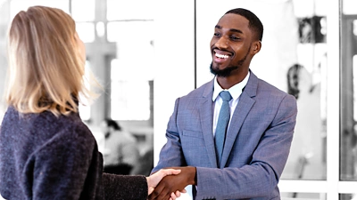 Man and woman shaking hands.