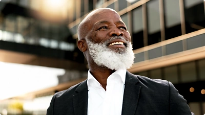 Man smiling and looking forward.