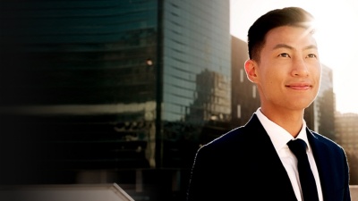 Businessperson in a suit standing near office buildings