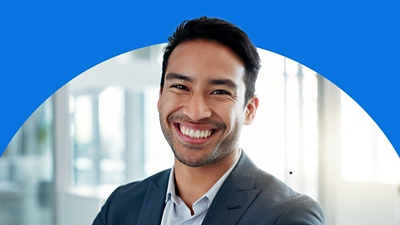Man smiling against blue background