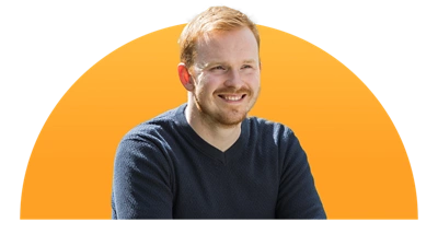 Image of a man smiling with a cantaloupe gradient in the back