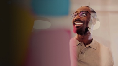 Business person casually dressed and smiling in an office setting