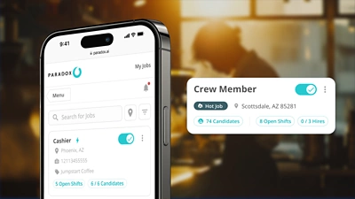 Close-up of the Workday Paradox mobile job management dashboard showing hiring goals and metrics for the 'Crew Member' role in Scottsdale, AZ. The screen displays key data points like '74 Candidates,' '8 Open Shifts,' and '0/3 Hires,' demonstrating the platform's ability to control candidate volume limits and track progress against automated hiring goals for specific jobs.
