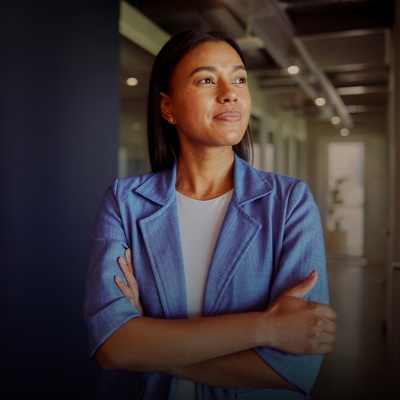 Person in an office, wearing a blazer and looking off-frame