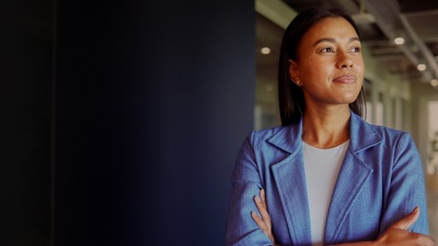 Person in an office, wearing a blazer and looking off-frame
