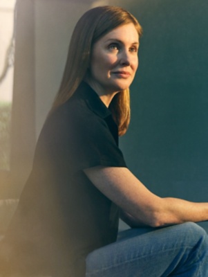 Woman sitting and looking next to window. 