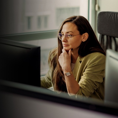 A woman focuses on her computer screen