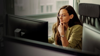 A woman focuses on her computer screen