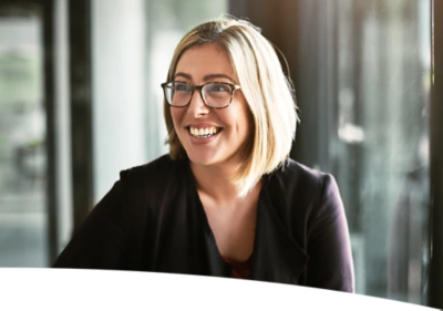 Woman with glasses smiling.