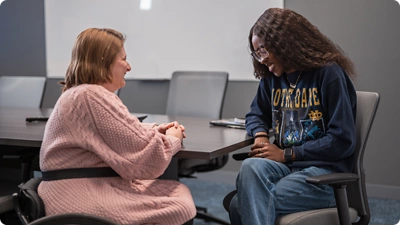 Two employees chatting in the office.