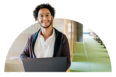 Man standing with a laptop.