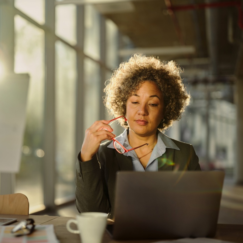 Female entrepreneur brainstorming on laptop