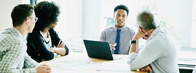 businessman leading meeting with clients