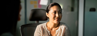 HR professional in Japan sitting at conference desk.