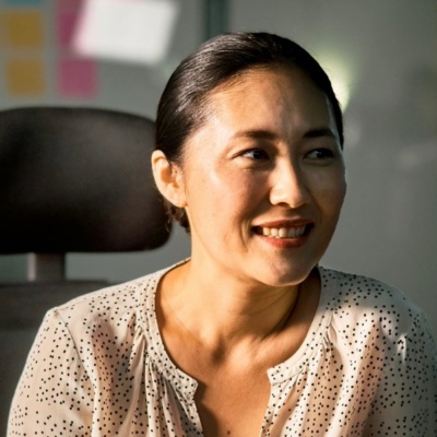 HR professional in Japan sitting at conference desk.