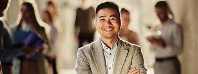 A photo of a business professional with their arms crossed.