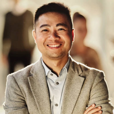 A photo of a business professional with their arms crossed.