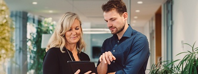 Man and woman looking at tablet together