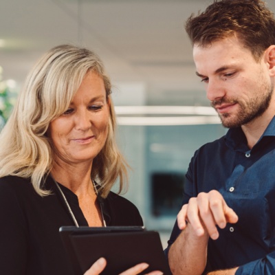 Man and woman looking at tablet together