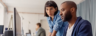 Man and woman looking at computer