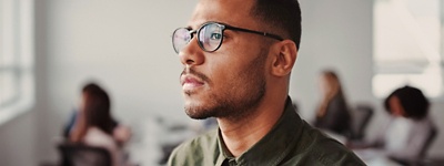 Man looking to side with glasses