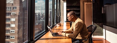 man on laptop in empty office