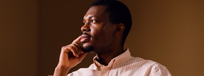 Man resting face on hand looking to the side