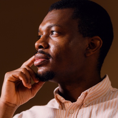 Man resting face on hand looking to the side