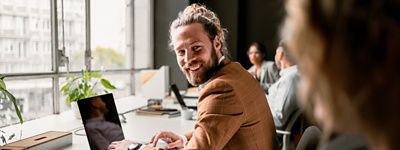 Man smiling back on laptop