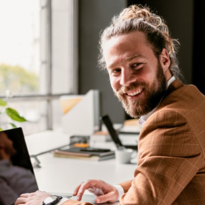 Man smiling back on laptop
