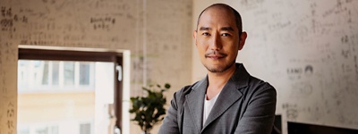 Man with arms crossed looking into camera