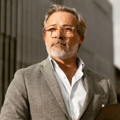 Man with glasses looking into the distance