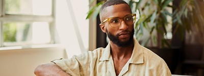 Man with glasses looking to the side