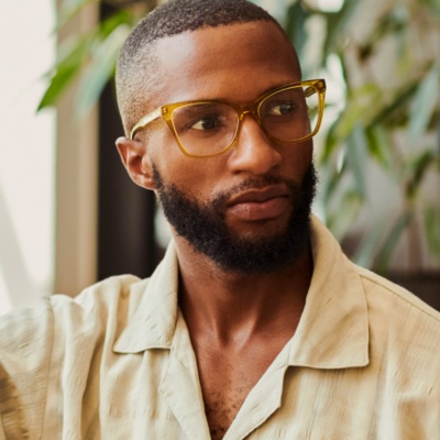 Man with glasses looking to the side