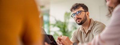 Man with glasses looking up