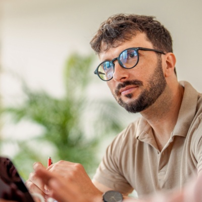 Man with glasses looking up