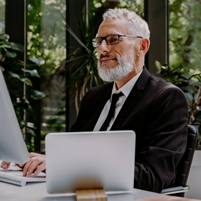 Man with glasses on laptop