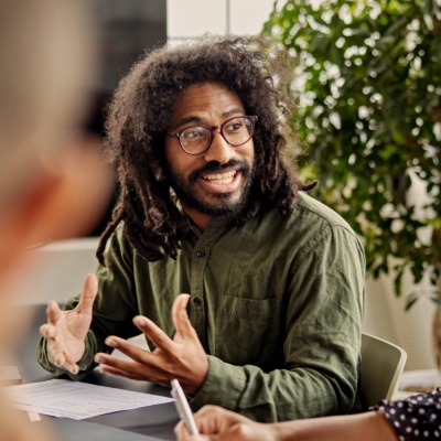 Man with glasses talking to colleagues