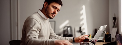 Man with serious expression working at desk
