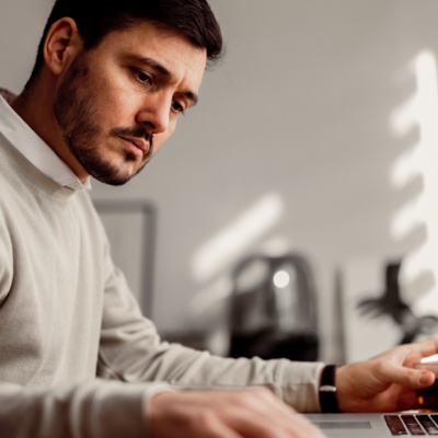 Man with serious expression working at desk