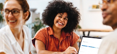 Group of happy employees working at a large table