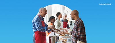 Industry Outlook image: People working in a volunteer setting handing out food