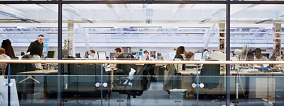 Employees working in an open floor plan office.