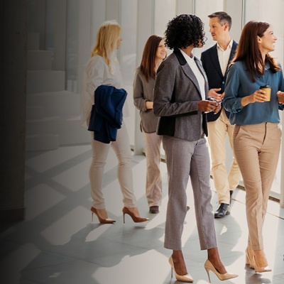 Group of professionals standing in windowed corridor