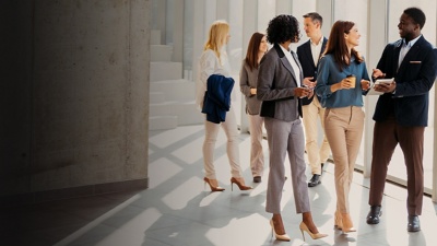 Group of professionals standing in windowed corridor
