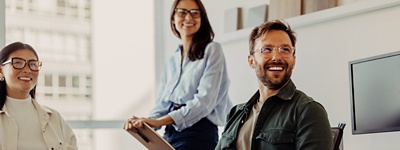 People in office looking and smiling