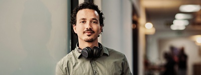 Person looking into camera with headphones on